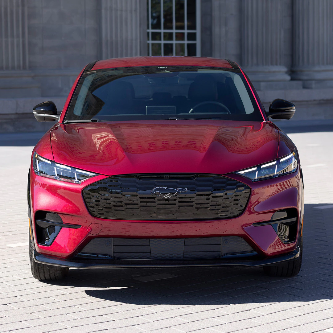 2026 Ford Mustang Mach-E in red, front view parked on brick surface
