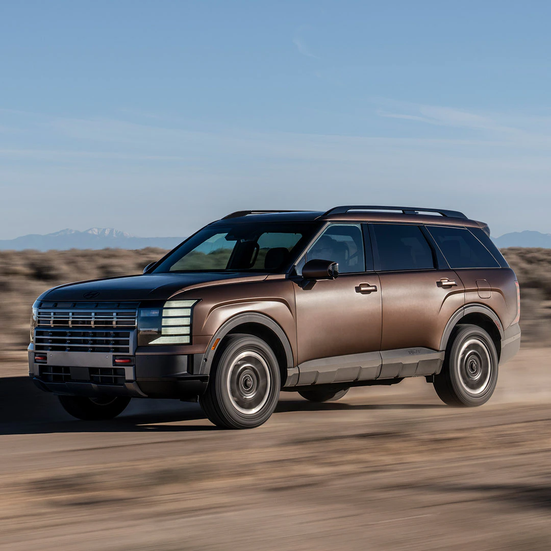 2026 Hyundai Palisade Hybrid driving across desert landscape